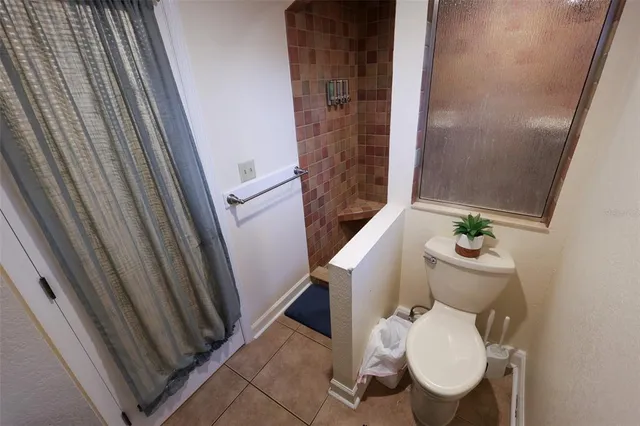 a white toilet sitting next to a small bathroom