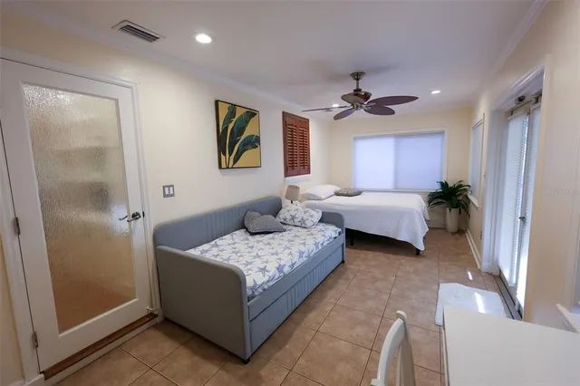 a bedroom with bed and a chandelier