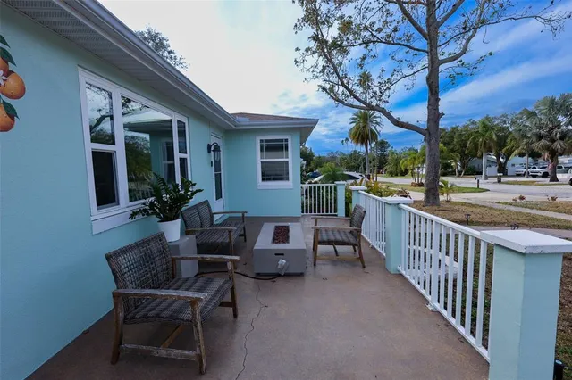 a view of a house with backyard and sitting area