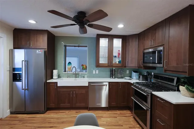 a kitchen with a sink stove and refrigerator