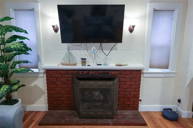 a living room with a fireplace and a flat screen tv