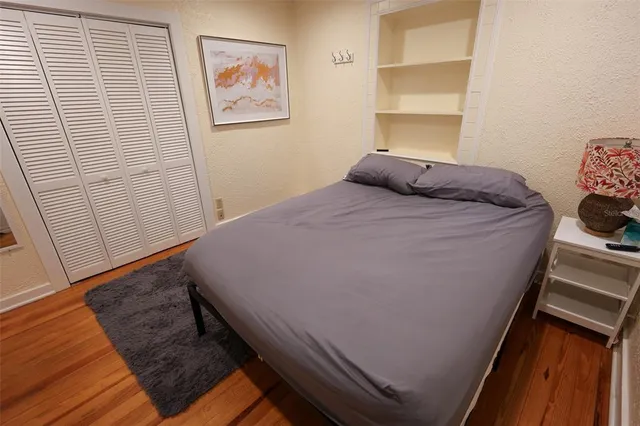 a bed sitting in a bedroom next to a window