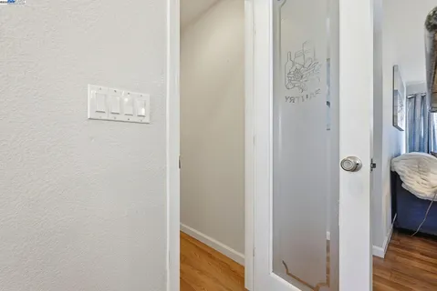 a view of a dining room and livingroom with furniture wooden floor a chandelier