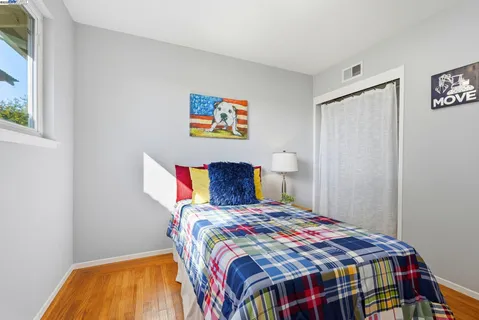 a bedroom with a bed and a potted plant