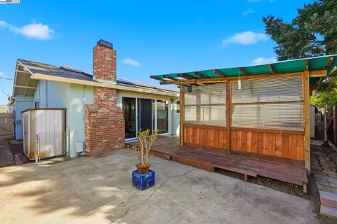 a view of balcony with two chairs and a potted plant