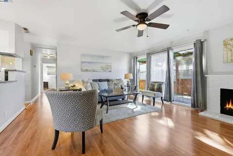 a living room with furniture and a wooden floor
