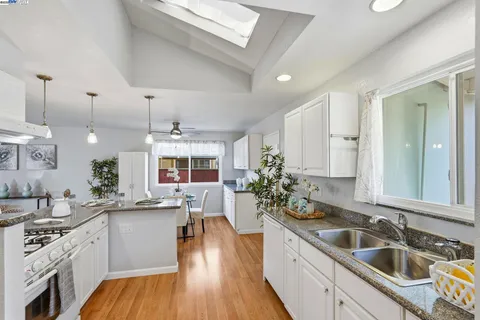 a kitchen with sink stove and cabinets