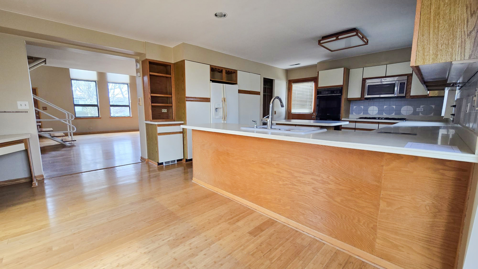 2736 Helen Drive Glenview, IL 60025 - Photo 16 of 47 a large kitchen with stainless steel appliances a large counter top stove and cabinets