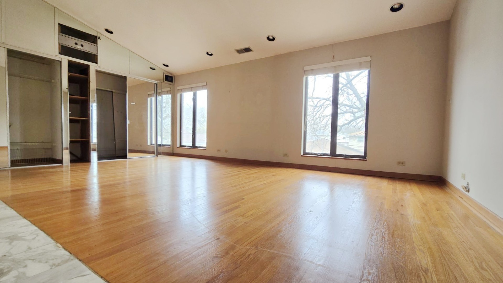 2736 Helen Drive Glenview, IL 60025 - Photo 43 of 47 an empty room with wooden floor and windows with curtains