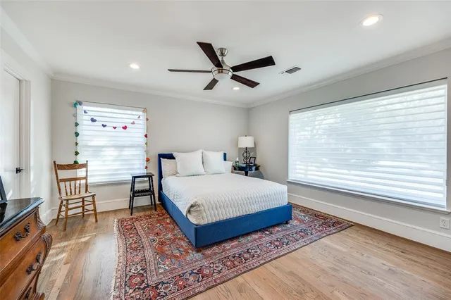 a spacious bedroom with a bed and a large window