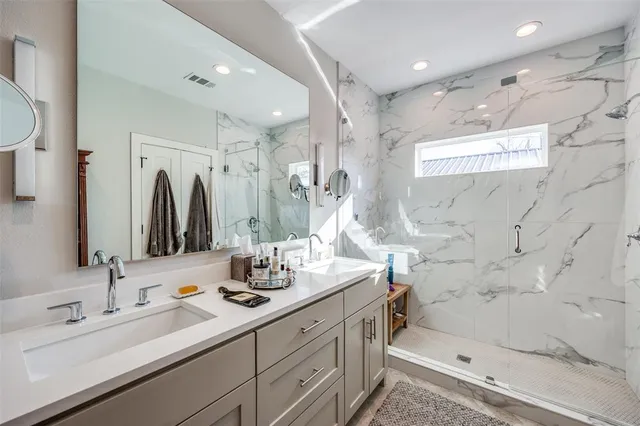 a bathroom with double vanity sink and a mirror