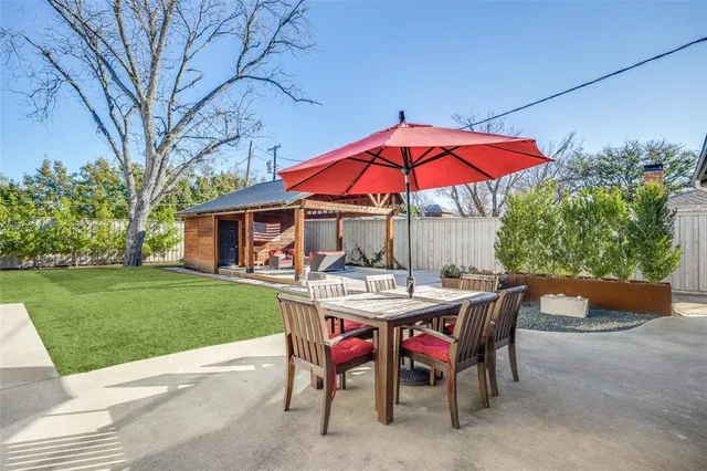 a view of a house with a yard and sitting area