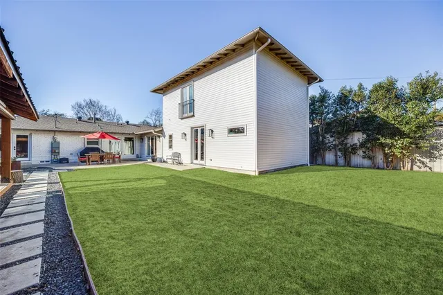 a view of an house with backyard space and garden