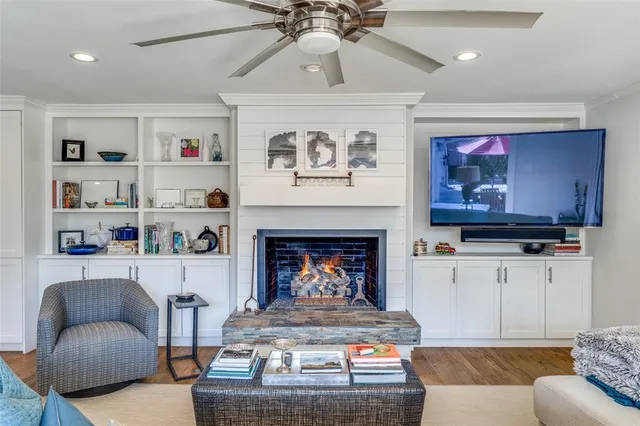 a living room with fireplace furniture and a wooden floor