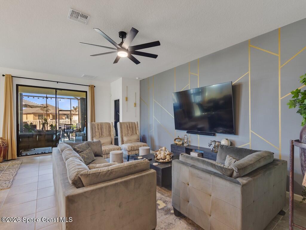 645 Old Country Rd S East Palm Bay, FL 32909 - Photo 13 of 42 a living room with furniture and a flat screen tv
