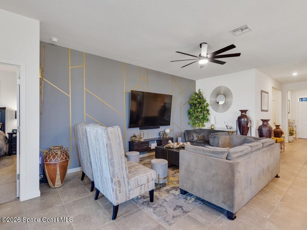 645 Old Country Rd S East Palm Bay, FL 32909 - Photo 14 of 42 a living room with furniture and a flat screen tv
