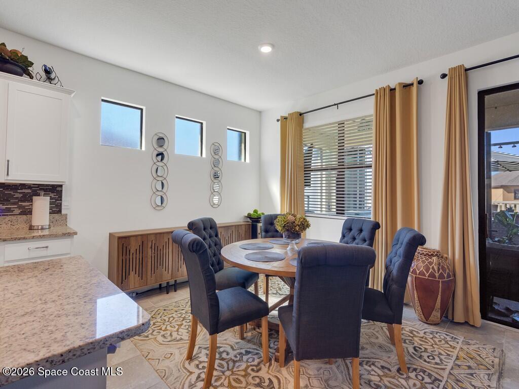 645 Old Country Rd S East Palm Bay, FL 32909 - Photo 15 of 42 a view of a dining room with furniture