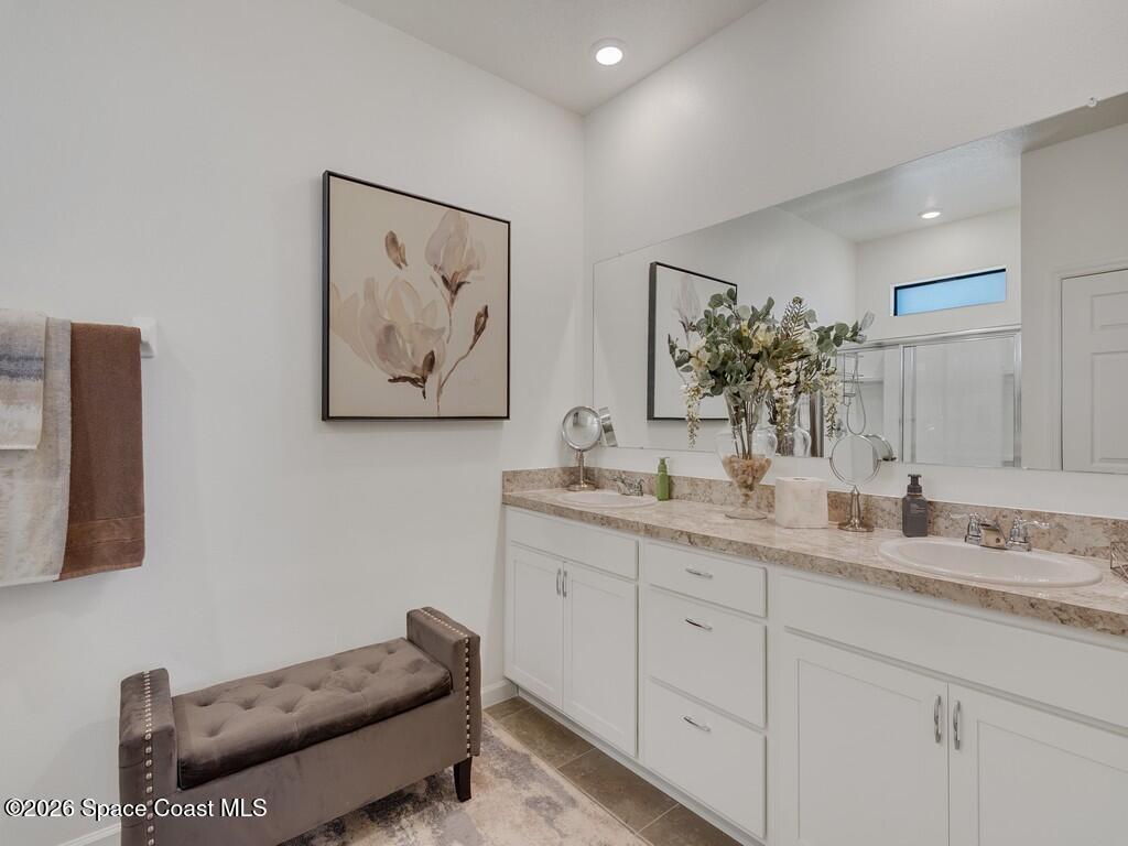 645 Old Country Rd S East Palm Bay, FL 32909 - Photo 17 of 42 a spacious bathroom with a double vanity sink and a mirror