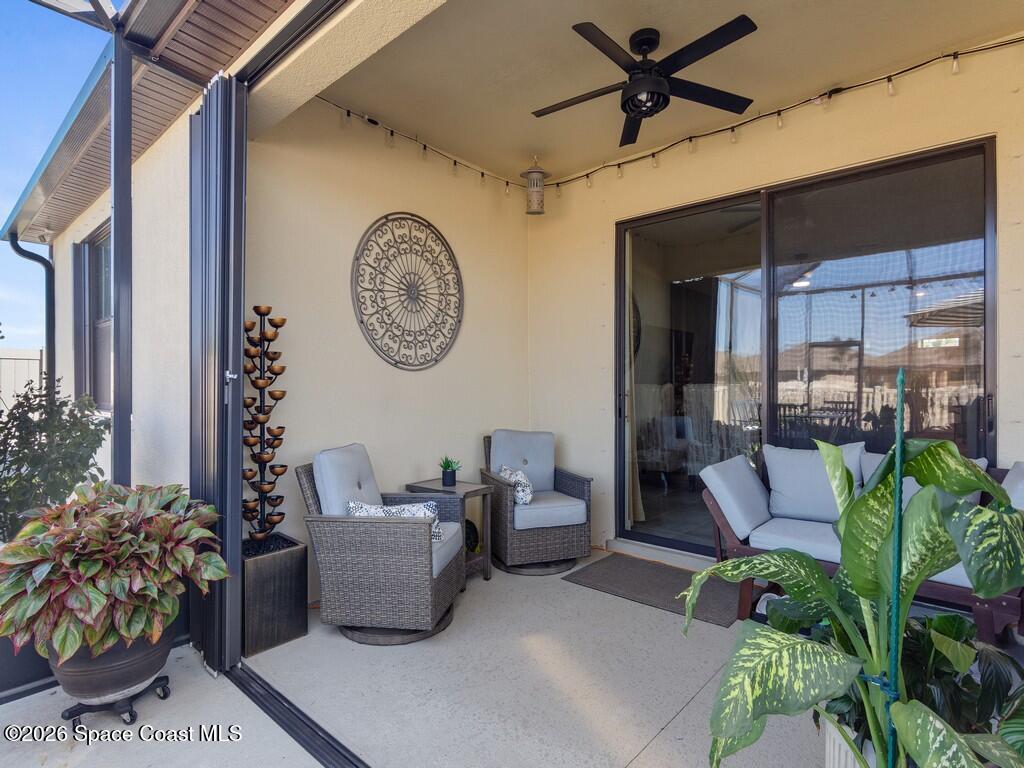 645 Old Country Rd S East Palm Bay, FL 32909 - Photo 19 of 42 a living room with patio outdoor seating and a potted plant