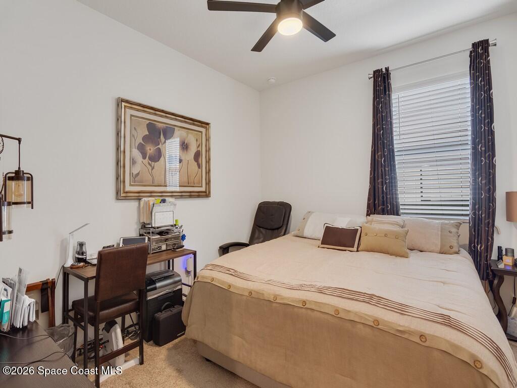 645 Old Country Rd S East Palm Bay, FL 32909 - Photo 22 of 42 a bedroom with a bed and a desk