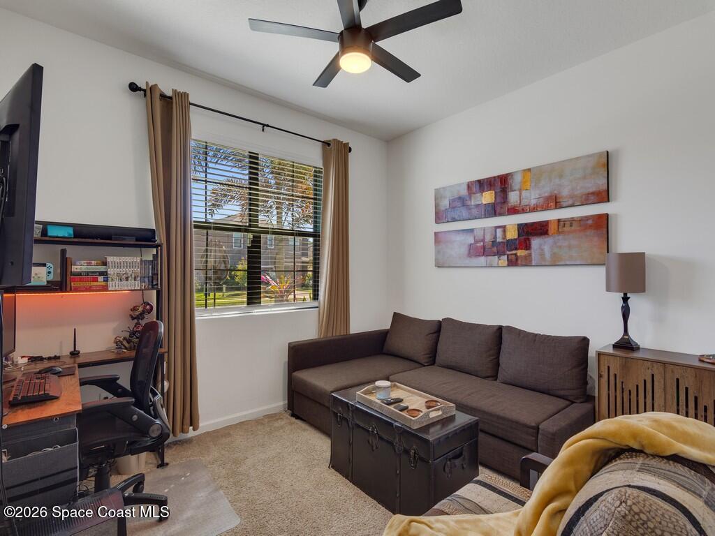 645 Old Country Rd S East Palm Bay, FL 32909 - Photo 23 of 42 a living room with furniture a ceiling fan and a window