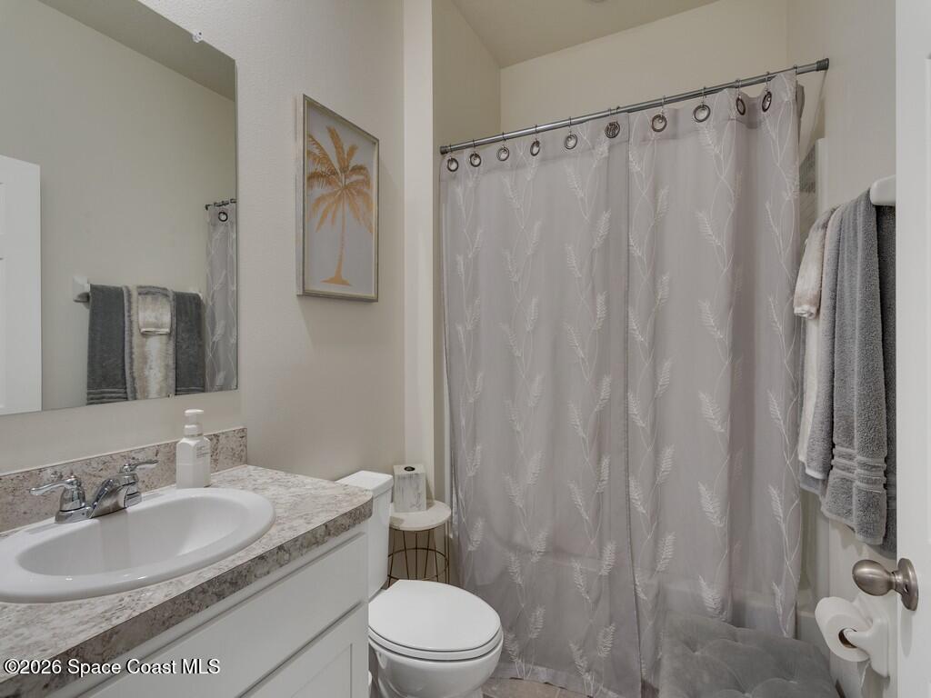 645 Old Country Rd S East Palm Bay, FL 32909 - Photo 24 of 42 a bathroom with a granite countertop sink toilet and shower