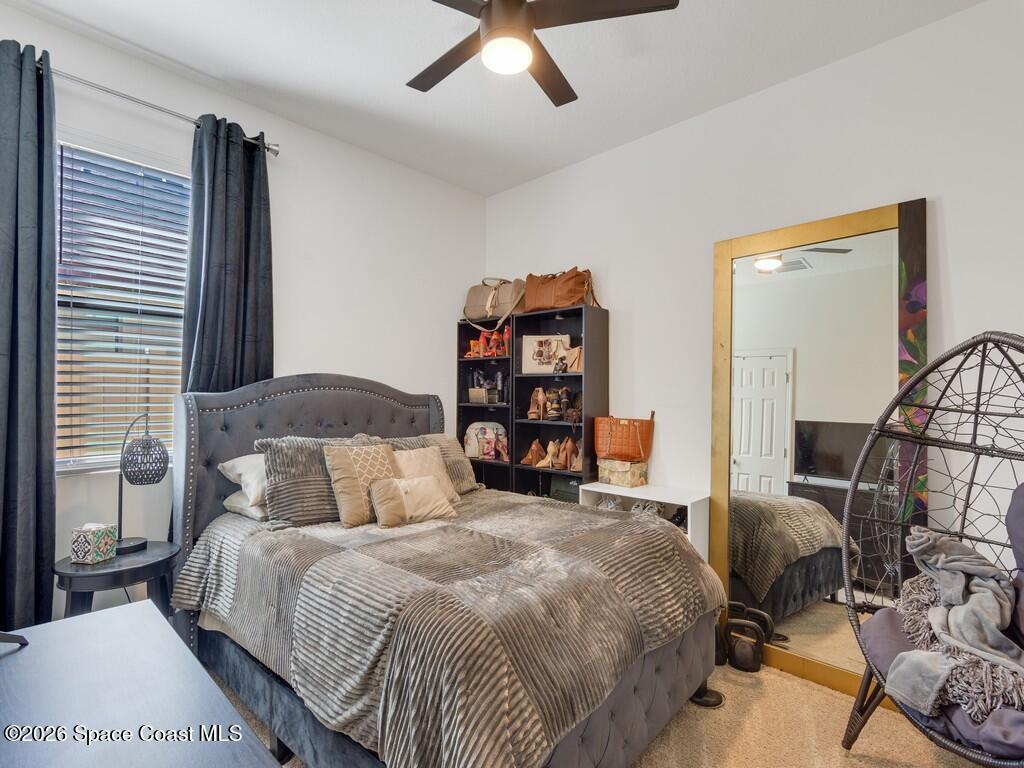 645 Old Country Rd S East Palm Bay, FL 32909 - Photo 25 of 42 a bedroom with a bed and dresser