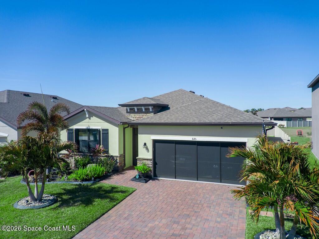 645 Old Country Rd S East Palm Bay, FL 32909 - Photo 39 of 42 a front view of a house with a yard and garage