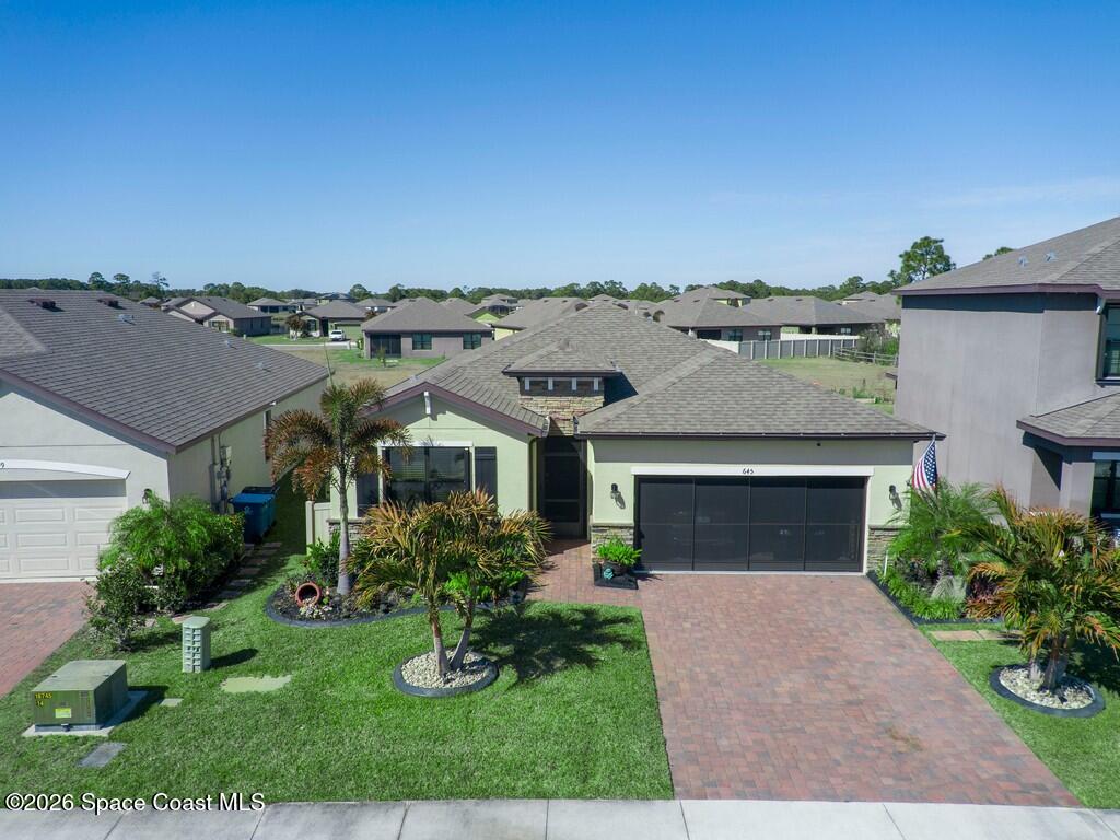 645 Old Country Rd S East Palm Bay, FL 32909 - Photo 40 of 42 a front view of a house with a yard and garage