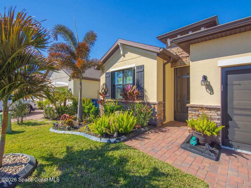 645 Old Country Rd S East Palm Bay, FL 32909 - Photo 9 of 42 a view of a house with a yard and plants