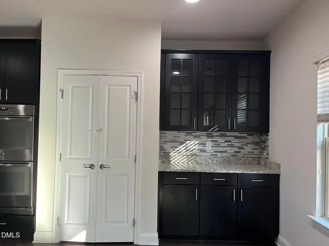 a kitchen with kitchen island granite countertop white cabinets and refrigerator