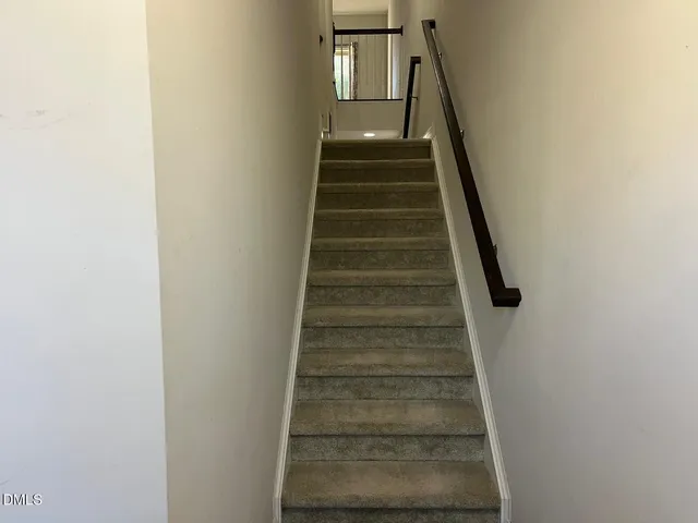 a kitchen with kitchen island granite countertop wooden cabinets and a refrigerator