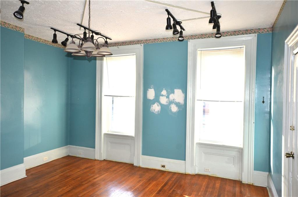 1198 3rd Street Beaver, PA 15009 - Photo 5 of 8 a view of a big room with chandelier fan and windows
