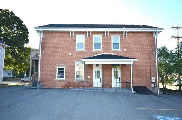 front view of brick house with a yard