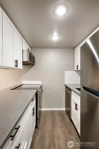a kitchen with a stove a sink and a refrigerator