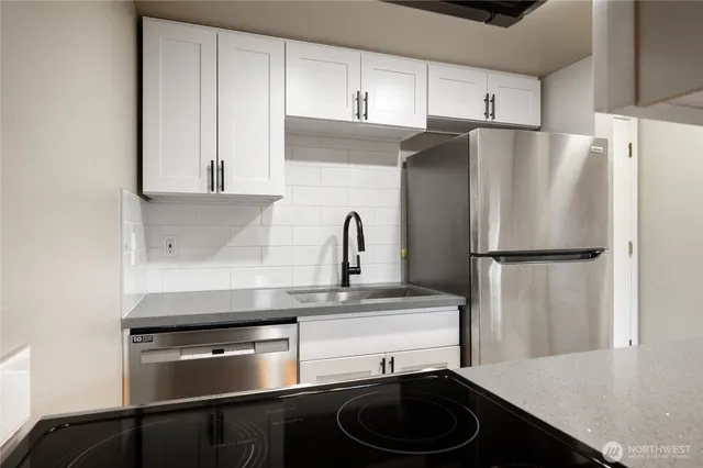 a kitchen with a refrigerator and a sink