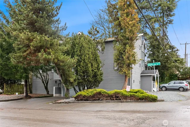 a couple of cars parked in front of a house