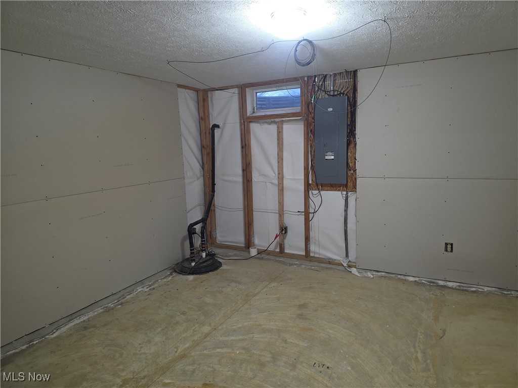 2291 Armstrong Road Wooster, OH 44691 - Photo 17 of 23 Mostly finished basement room with a textured ceiling, sump pump and electric panel