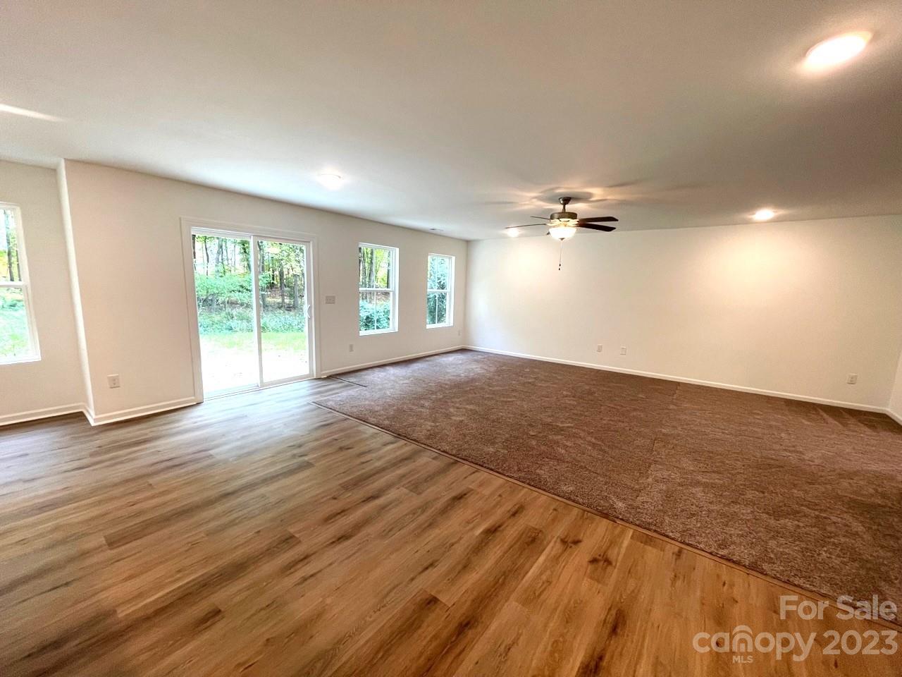 2173 Country Club Drive Lancaster, SC 29720 - Photo 11 of 18 a view of an empty room with a window and wooden floor