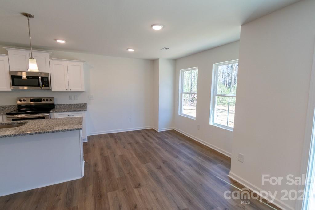 2173 Country Club Drive Lancaster, SC 29720 - Photo 12 of 18 a kitchen with granite countertop a stove a sink and a microwave