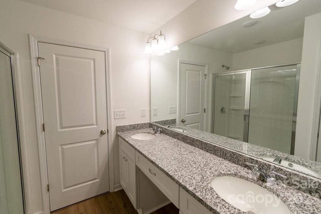 2173 Country Club Drive Lancaster, SC 29720 - Photo 17 of 18 a bathroom with a granite countertop double vanity sink and mirror