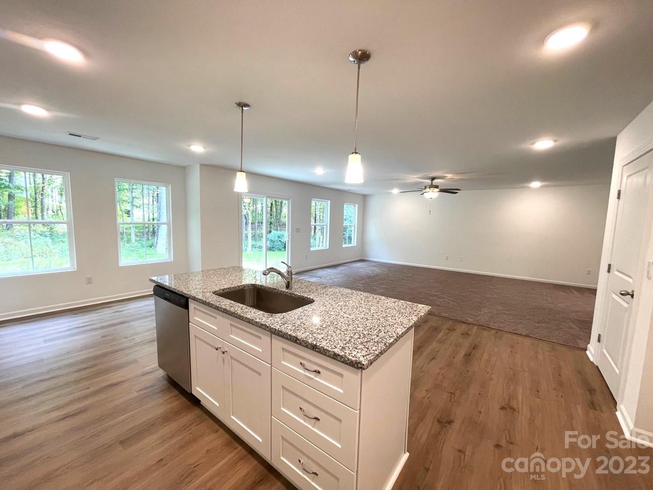2173 Country Club Drive Lancaster, SC 29720 - Photo 10 of 18 a kitchen with kitchen island a sink stove and wooden floor