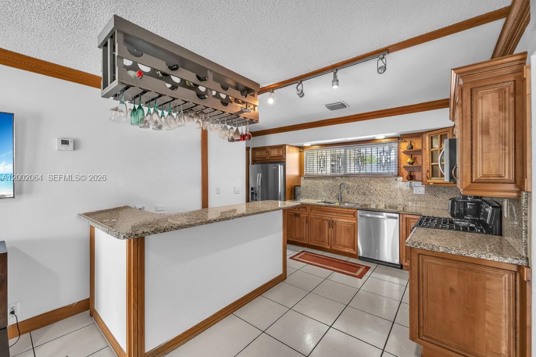 12310 Southwest 39th Terrace Miami, FL 33175 - Photo 11 of 42 a kitchen with stainless steel appliances granite countertop a sink and cabinets