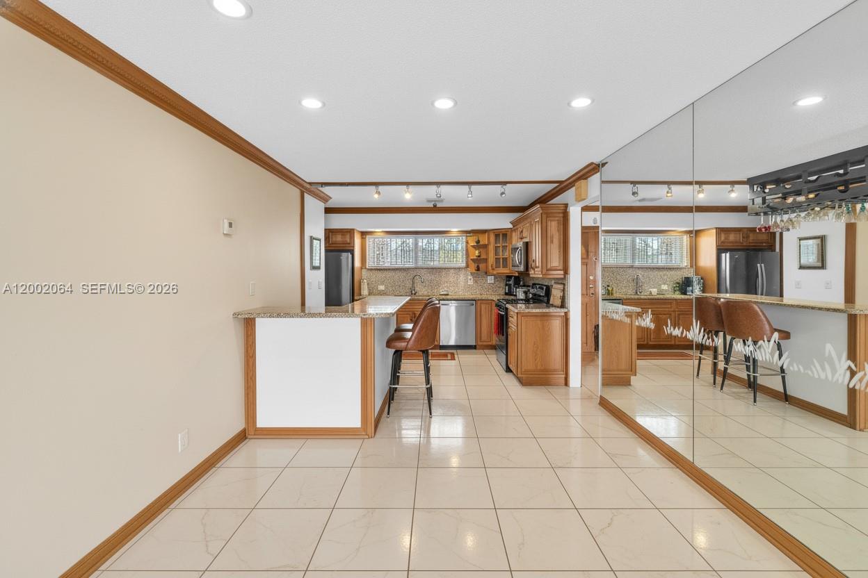 12310 Southwest 39th Terrace Miami, FL 33175 - Photo 13 of 42 a dining hall with stainless steel appliances a refrigerator and cabinets