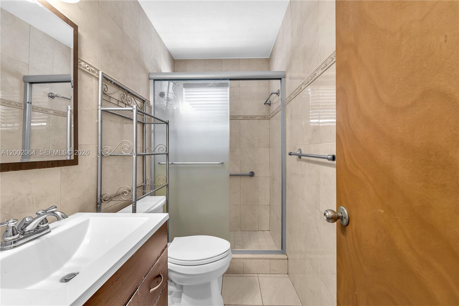 12310 Southwest 39th Terrace Miami, FL 33175 - Photo 15 of 42 a bathroom with a sink toilet and shower