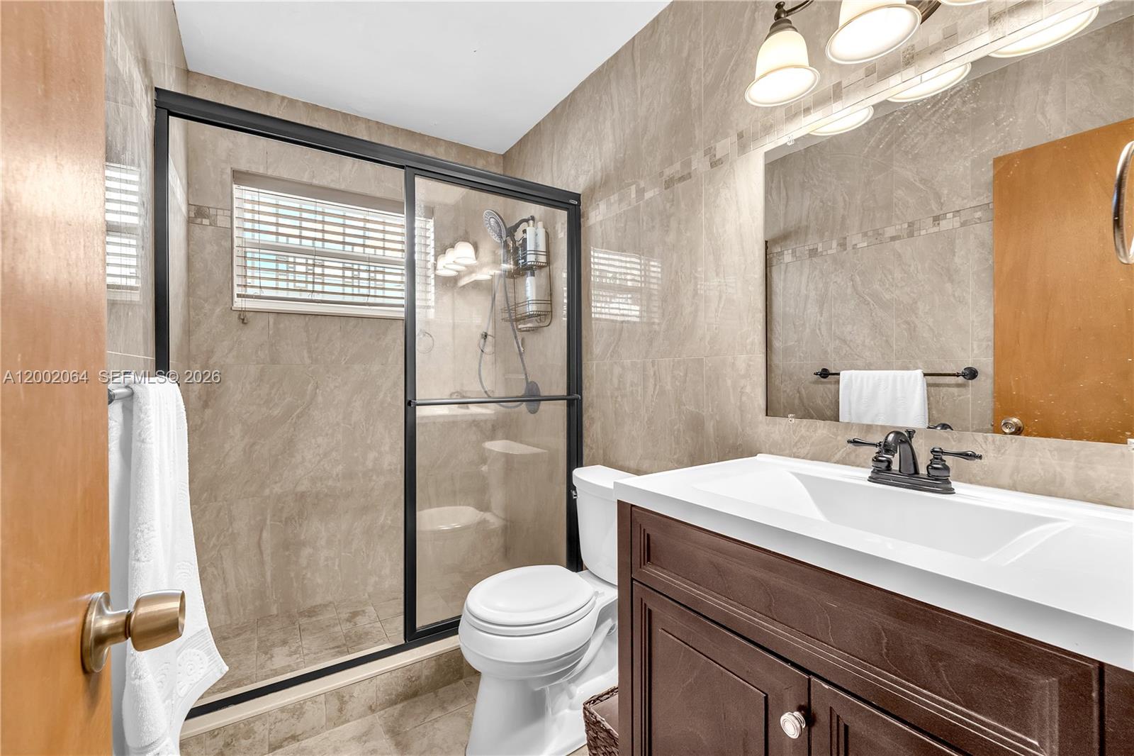 12310 Southwest 39th Terrace Miami, FL 33175 - Photo 16 of 42 a bathroom with a sink toilet and shower