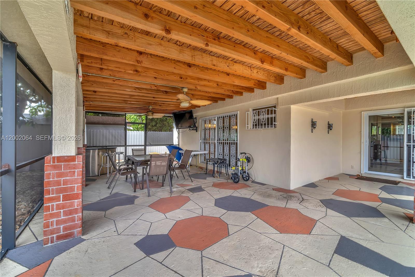 12310 Southwest 39th Terrace Miami, FL 33175 - Photo 22 of 42 a outdoor space with lots of tables a chair and a glass door with glass windows