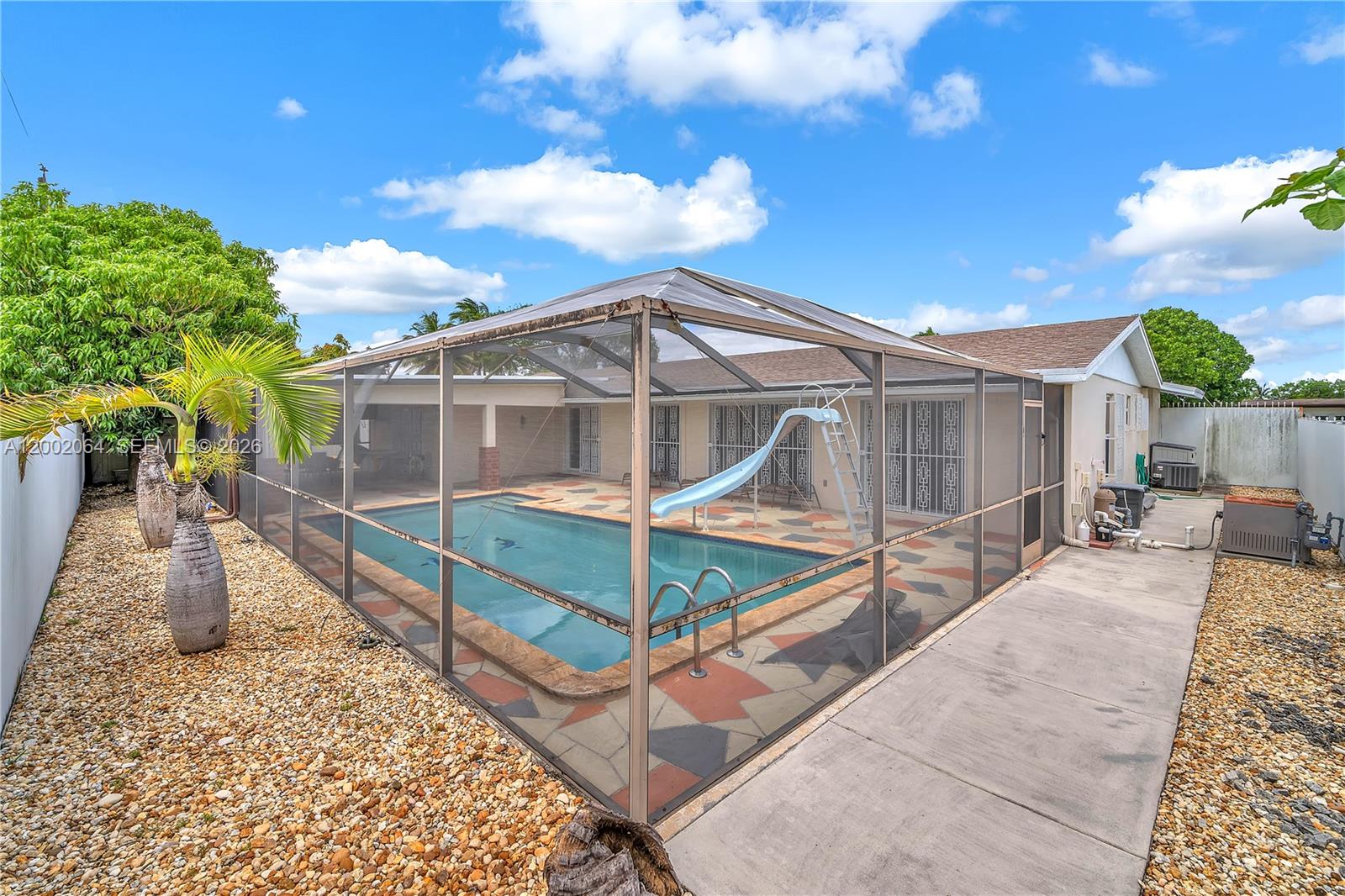 12310 Southwest 39th Terrace Miami, FL 33175 - Photo 24 of 42 a view of a house with pool and wooden fence