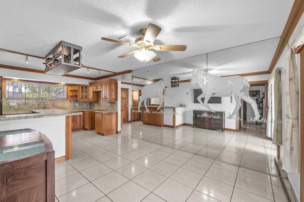 12310 Southwest 39th Terrace Miami, FL 33175 - Photo 10 of 42 a large white kitchen with cabinets and a stove