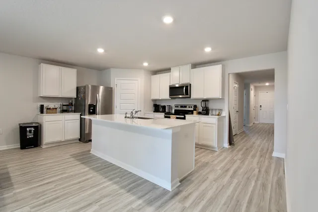a living room with furniture flat screen tv and wooden floor